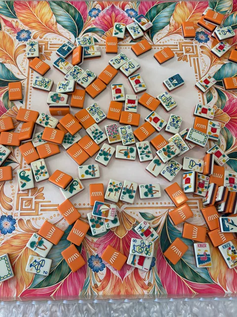 Universal Tropics Mahjong mat on a real table with orange tiles