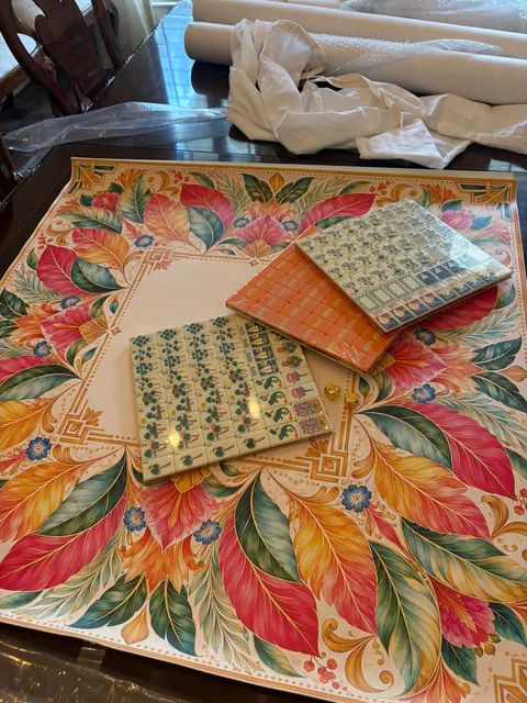 Universal Tropics Mahjong mat unrolled on a table with stacked tiles